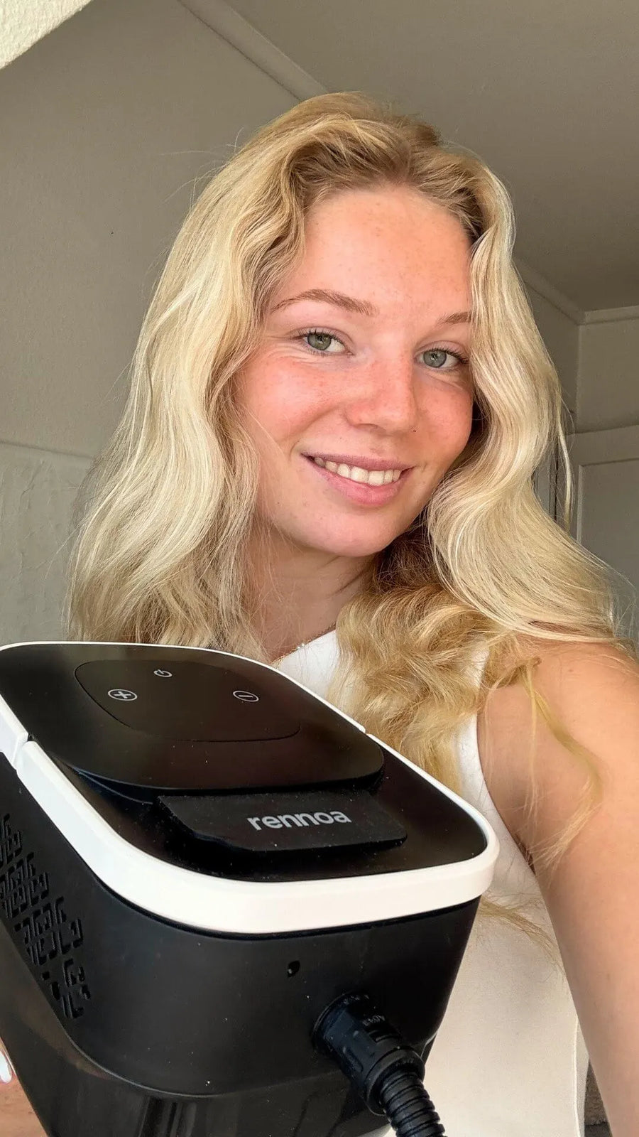 Person holding steam cleaner in hand