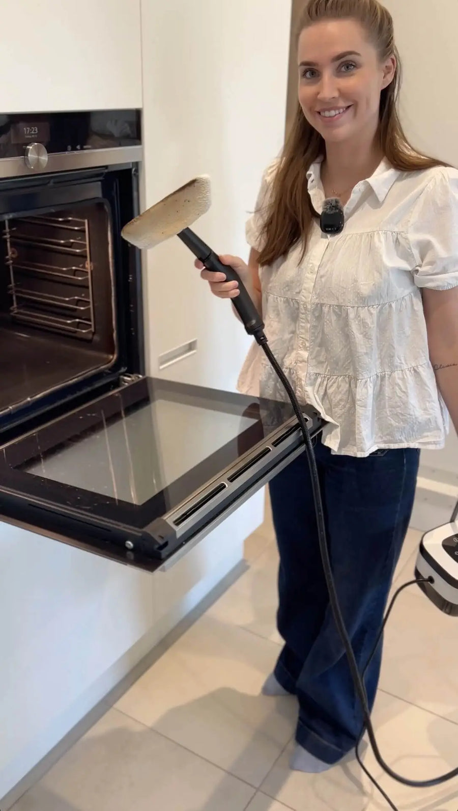 Person holding steam cleaner in hand