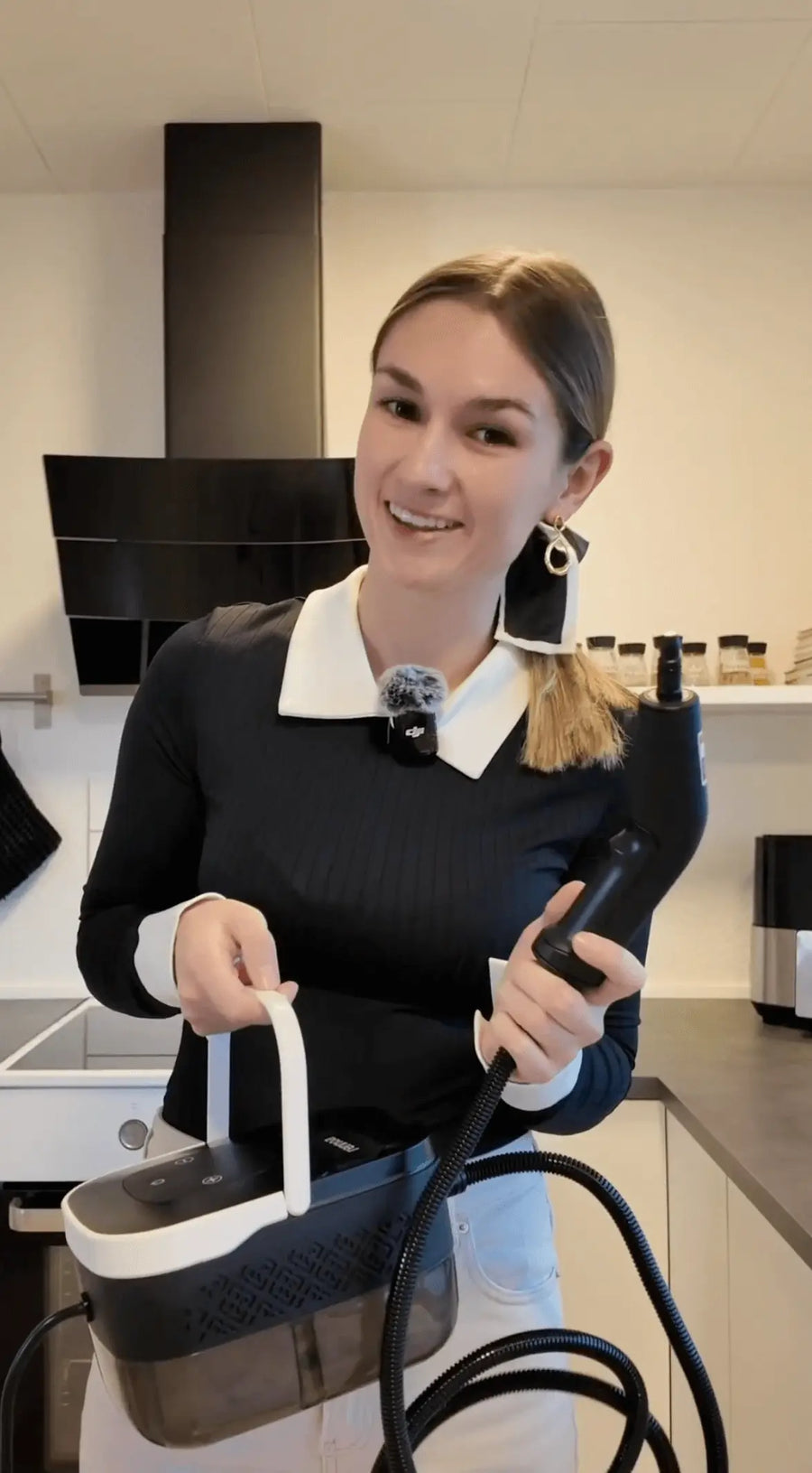 Person holding steam cleaner in hand