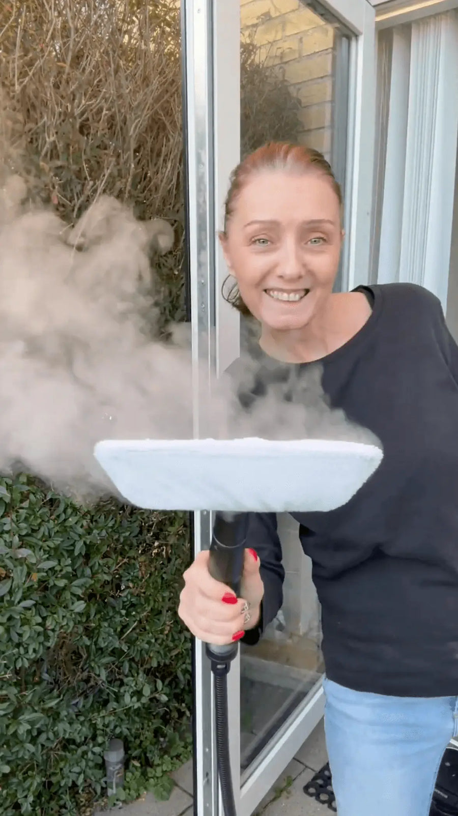 Person holding steam cleaner in hand